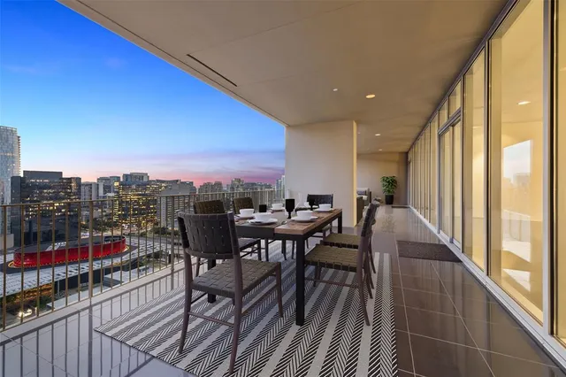 a view of a roof deck with table and chairs