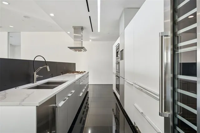 a kitchen with a sink and refrigerator