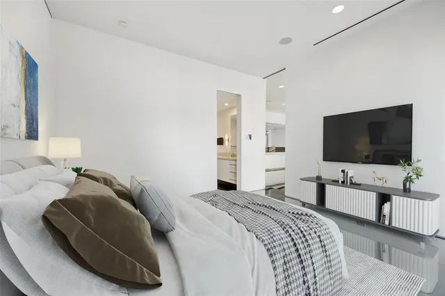 a bedroom with a bed and a flat screen tv