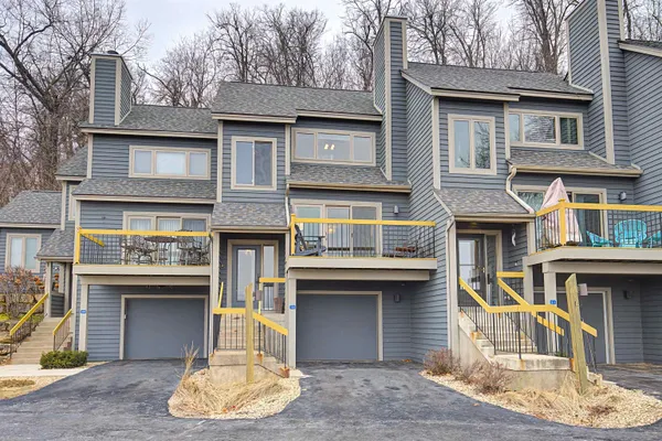 a front view of a residential apartment building with a yard