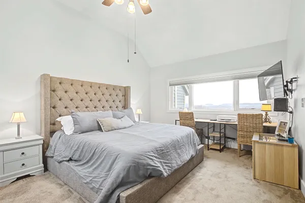 a bedroom with a bed and a large window