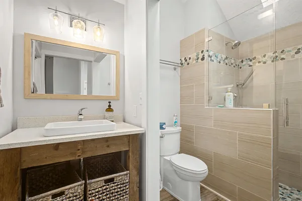 a bathroom with a sink toilet and a mirror