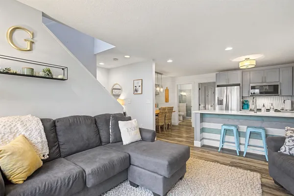 a living room with furniture and kitchen view