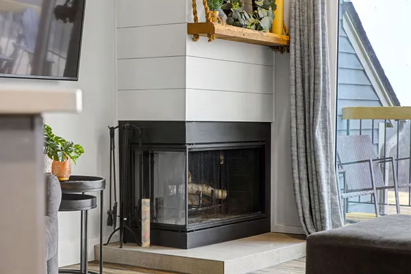 a living room with a fireplace and a window