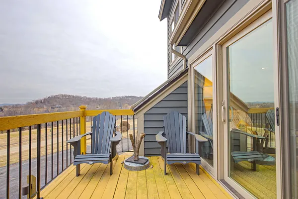 a view of a balcony with wooden floor and fence