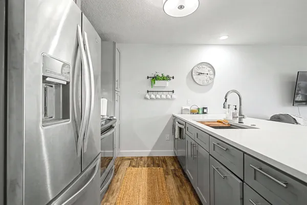 a kitchen with a sink and a refrigerator