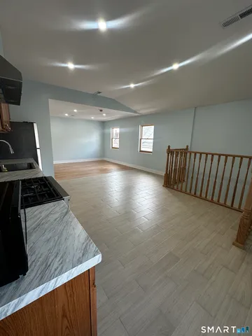 a kitchen with stainless steel appliances granite countertop a stove a sink and a refrigerator