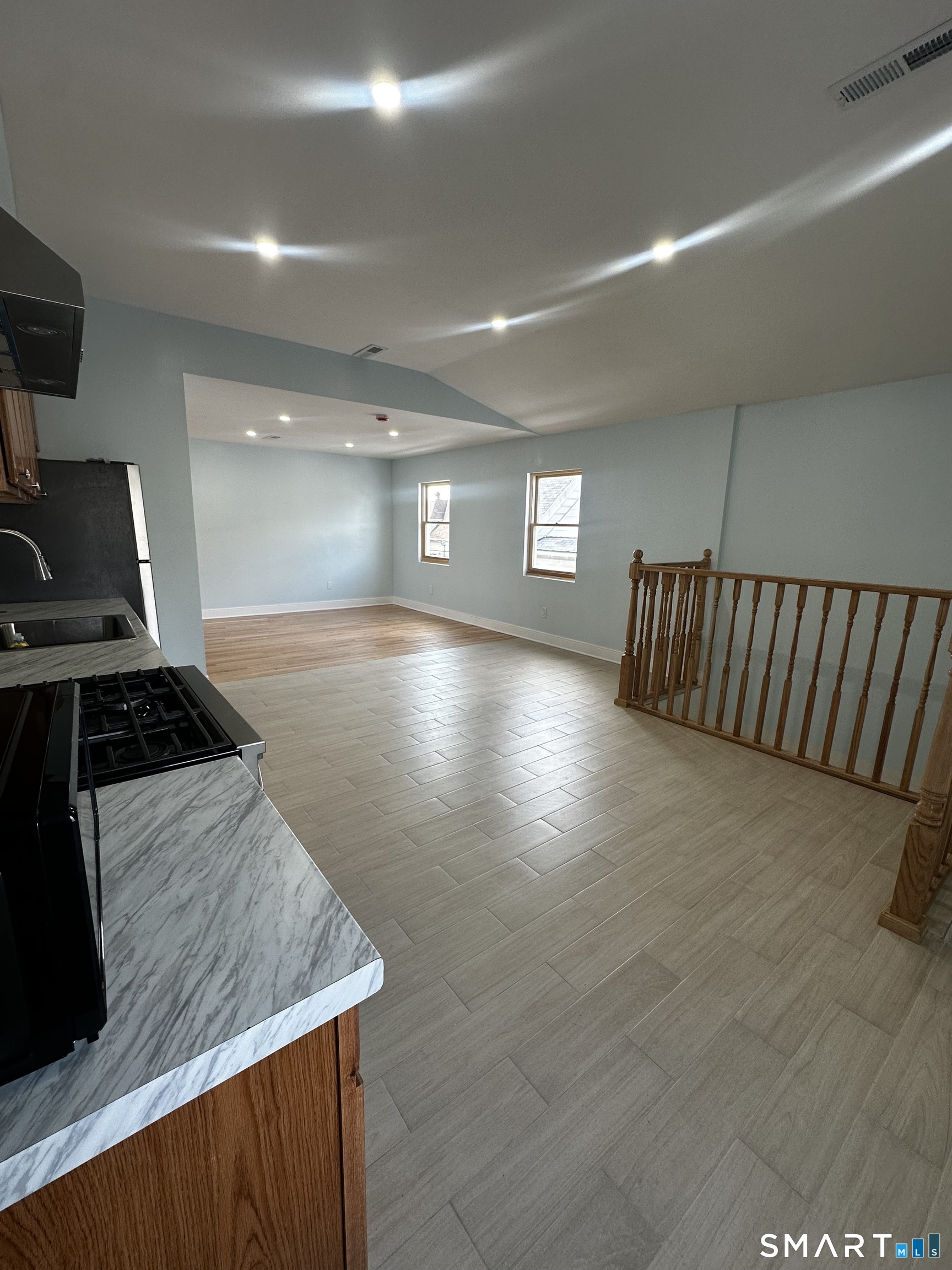 185 Alpine Street, Unit 3 Bridgeport, CT 06610 - Photo 3 of 7 a kitchen with stainless steel appliances granite countertop a stove a sink and a refrigerator
