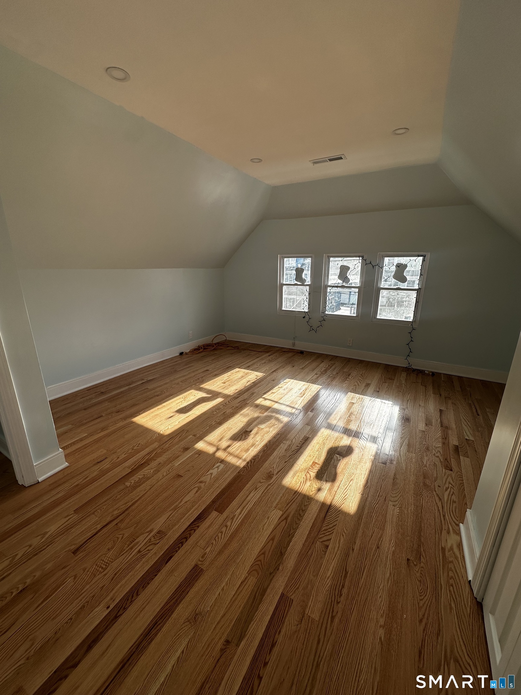 185 Alpine Street, Unit 3 Bridgeport, CT 06610 - Photo 6 of 7 a view of empty room with wooden floor and fan