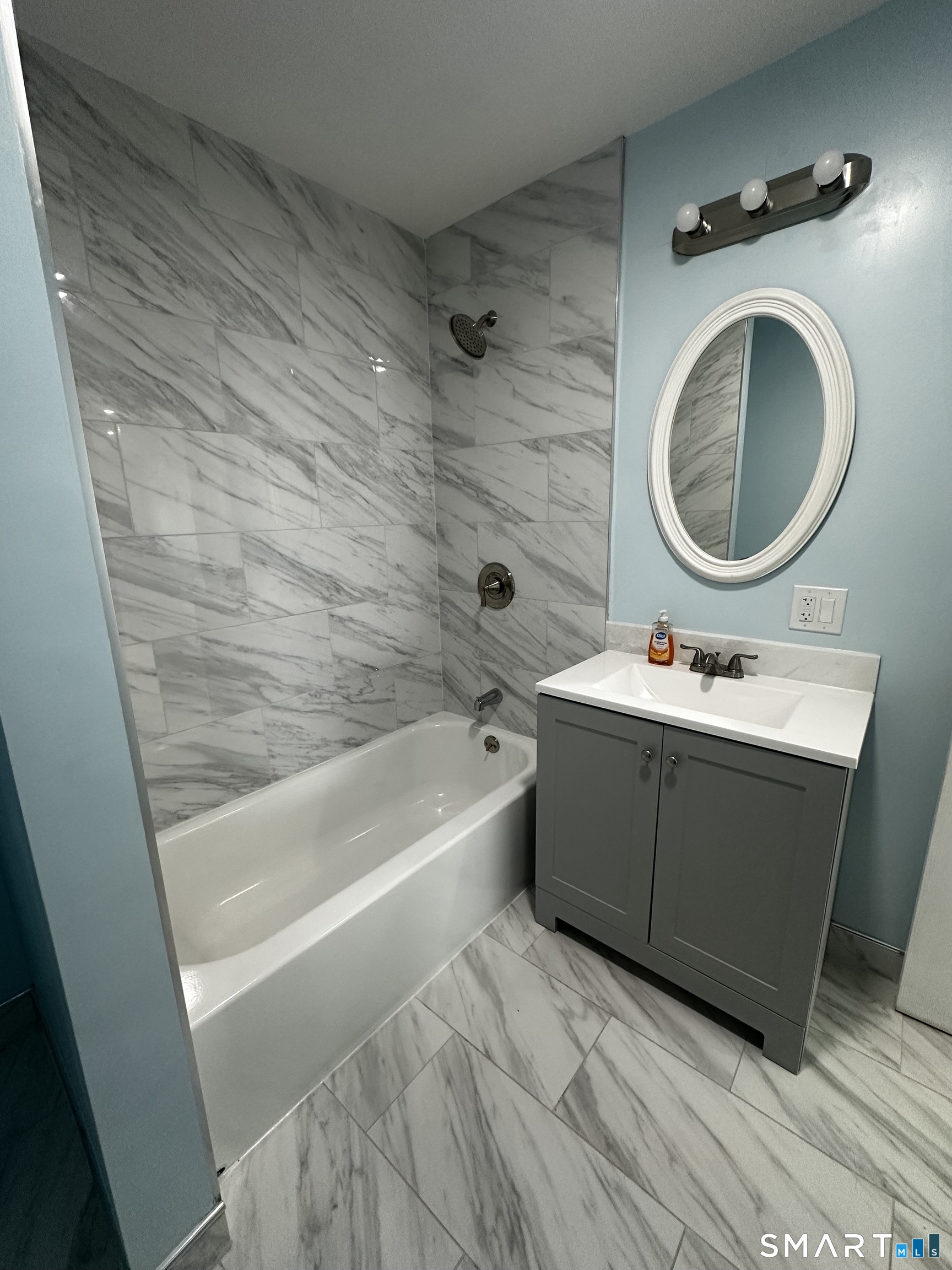 185 Alpine Street, Unit 3 Bridgeport, CT 06610 - Photo 7 of 7 a bathroom with a bathtub sink vanity mirror and toilet