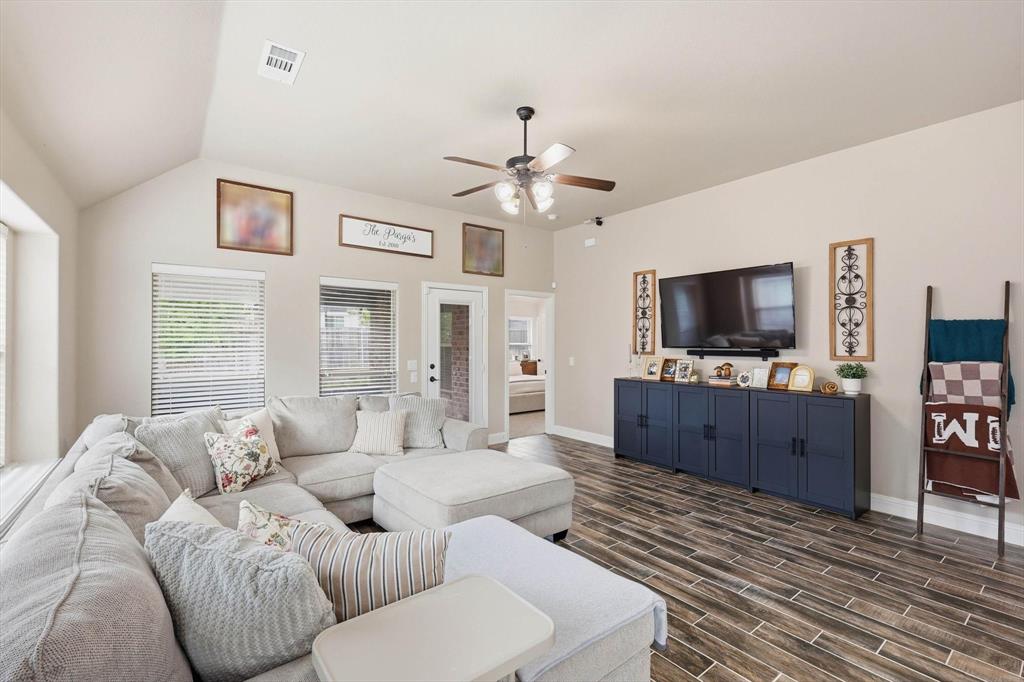 324 Sherbrook Street Van Alstyne, TX 75495 - Photo 12 of 27 a living room with furniture a flat screen tv and a chandelier
