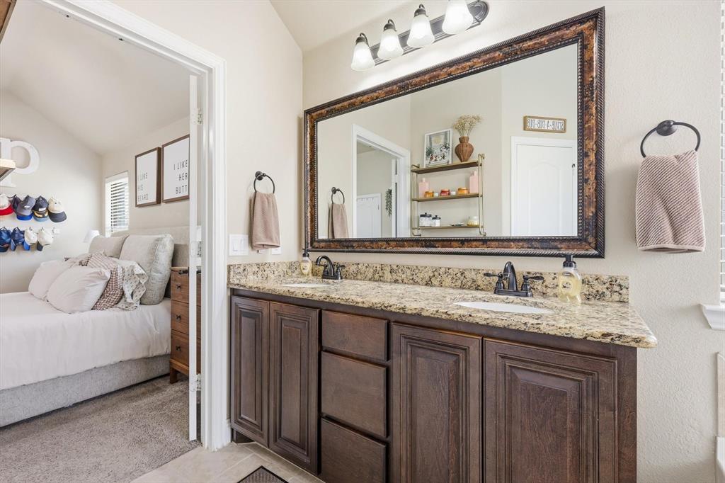 324 Sherbrook Street Van Alstyne, TX 75495 - Photo 16 of 27 a bathroom with a double vanity sink and a mirror