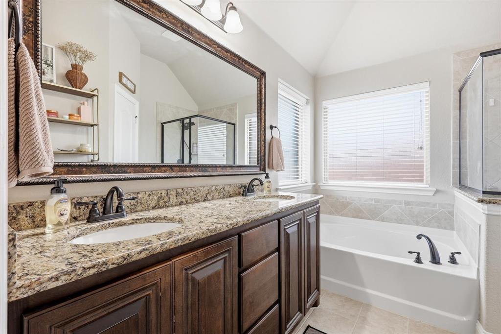 324 Sherbrook Street Van Alstyne, TX 75495 - Photo 17 of 27 a bathroom with a granite countertop bathtub a double vanity sink and mirror