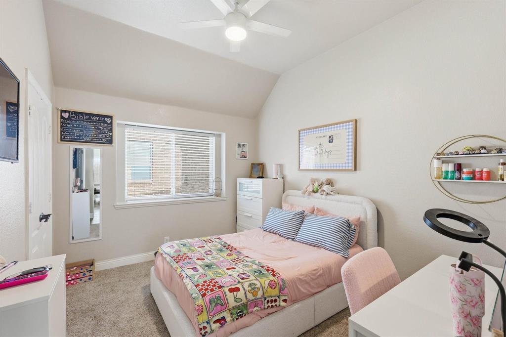 324 Sherbrook Street Van Alstyne, TX 75495 - Photo 19 of 27 a bedroom with a bed and a chandelier