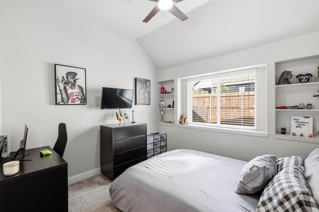 324 Sherbrook Street Van Alstyne, TX 75495 - Photo 21 of 27 a bedroom with a bed a flat screen tv and a window