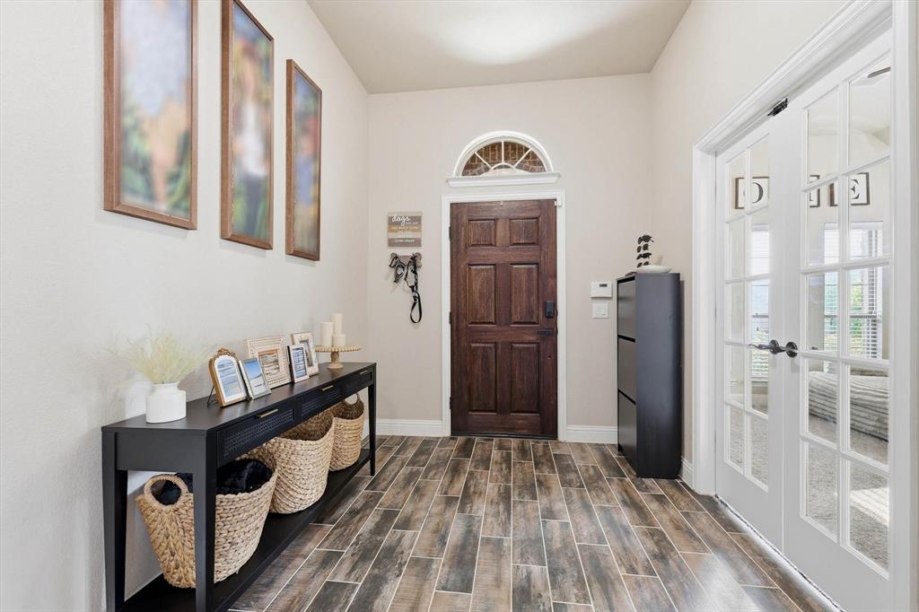 324 Sherbrook Street Van Alstyne, TX 75495 - Photo 3 of 27 a view of a hallway with elevator with wooden floor