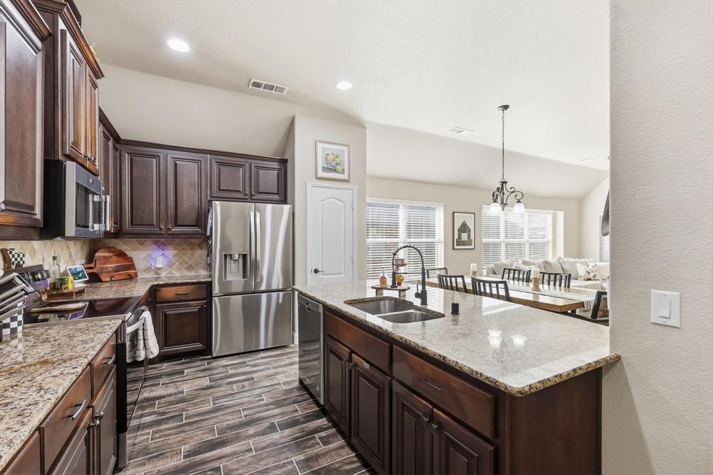 324 Sherbrook Street Van Alstyne, TX 75495 - Photo 6 of 27 a kitchen with a sink stove and refrigerator