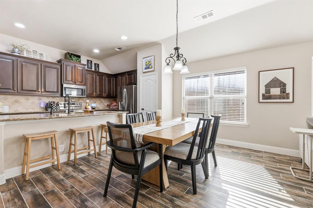 324 Sherbrook Street Van Alstyne, TX 75495 - Photo 9 of 27 a view of a dining room with furniture window and wooden floor