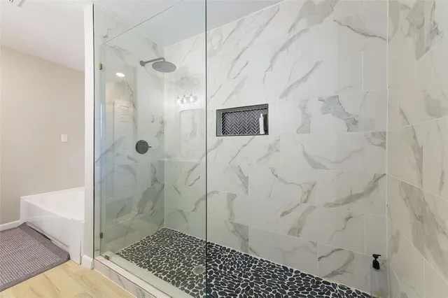 a spacious bedroom with a bed and a television