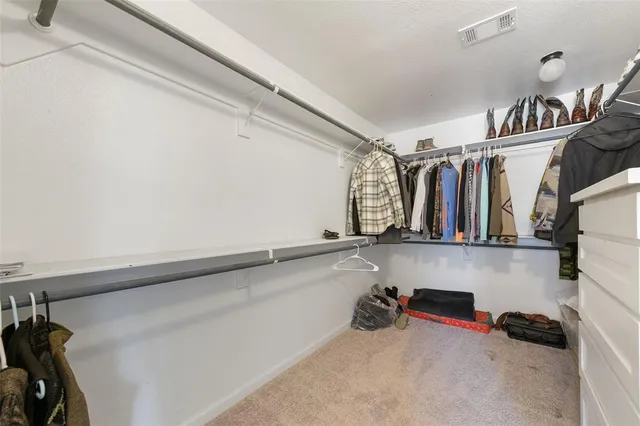 a view of a livingroom with wooden floor a fireplace and window