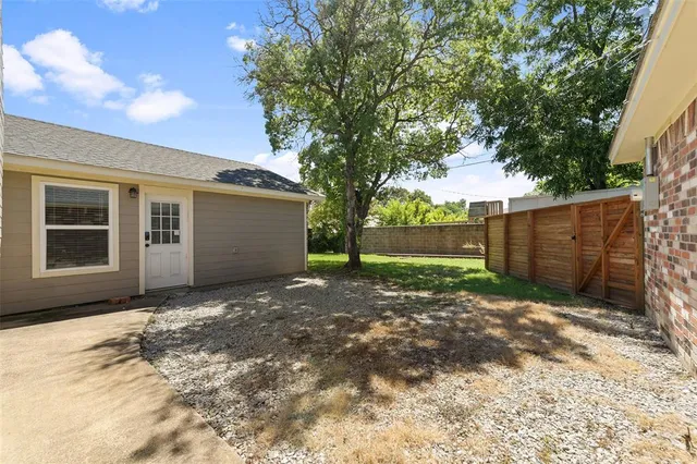 an empty room with a window and a ceiling fan