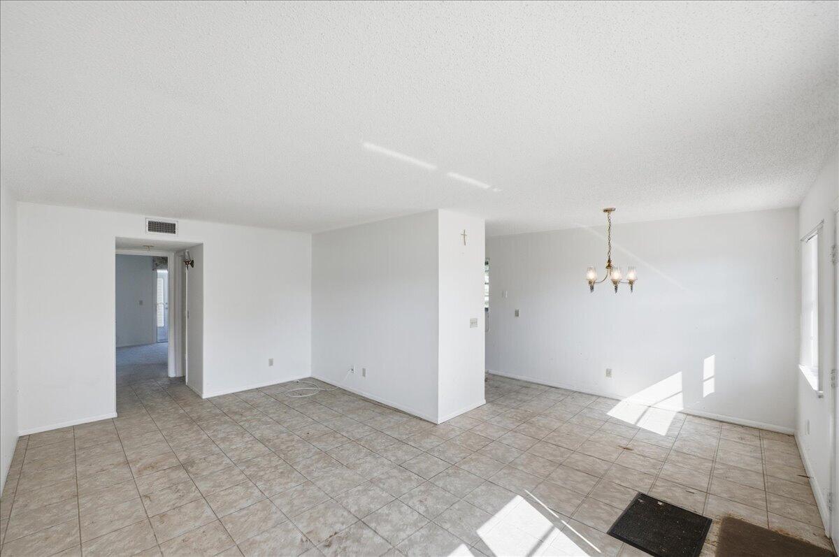 28 Lake Vista Trail, Unit 105 Port St. Lucie, FL 34952 - Photo 12 of 26 wooden floor in an empty room