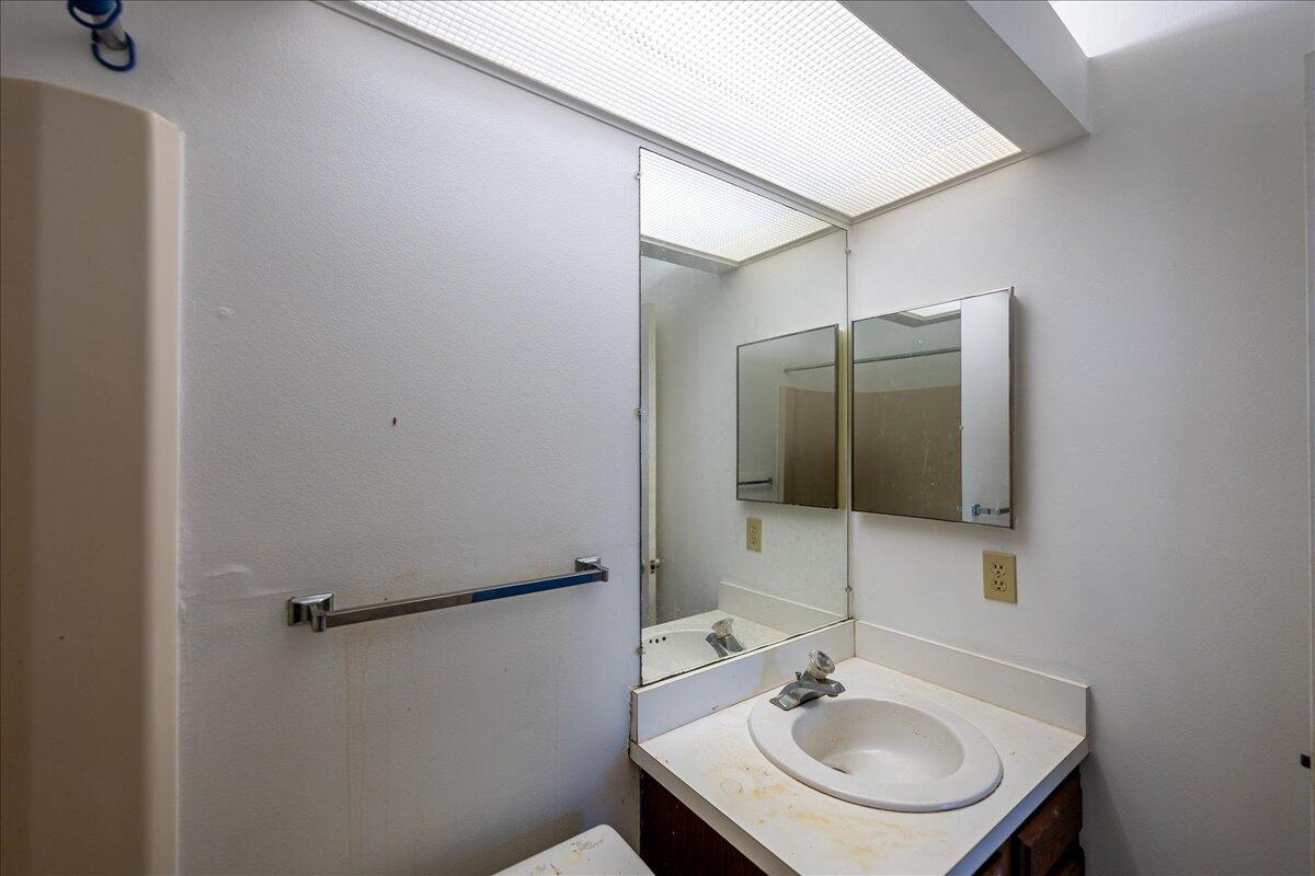 28 Lake Vista Trail, Unit 105 Port St. Lucie, FL 34952 - Photo 14 of 26 a bathroom with a sink and a mirror