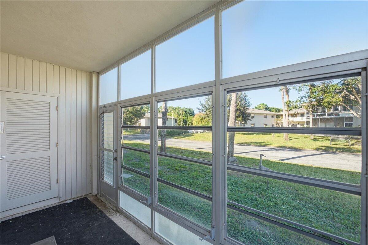 28 Lake Vista Trail, Unit 105 Port St. Lucie, FL 34952 - Photo 17 of 26 a view of a living room and a floor to ceiling window