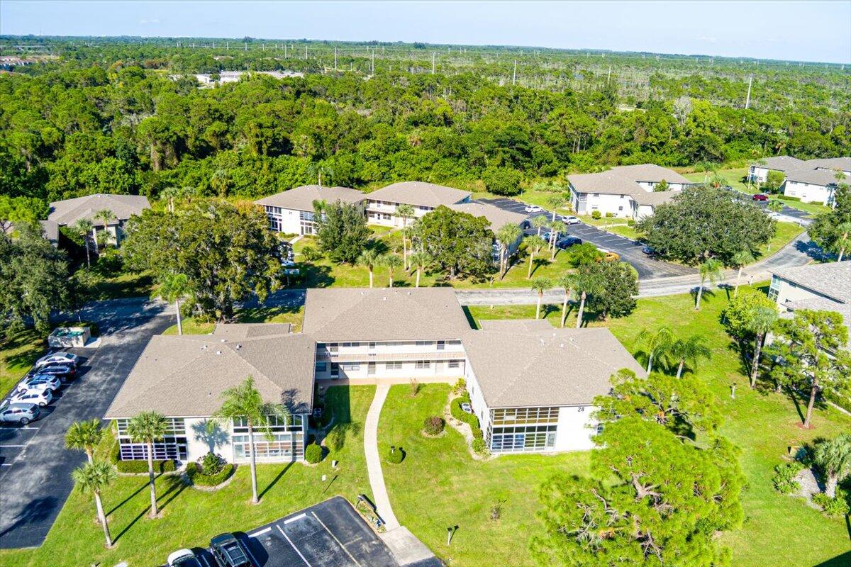 28 Lake Vista Trail, Unit 105 Port St. Lucie, FL 34952 - Photo 2 of 26 an aerial view of residential houses with outdoor space and trees
