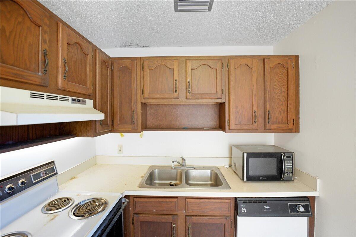 28 Lake Vista Trail, Unit 105 Port St. Lucie, FL 34952 - Photo 7 of 26 a kitchen with a stove and a sink