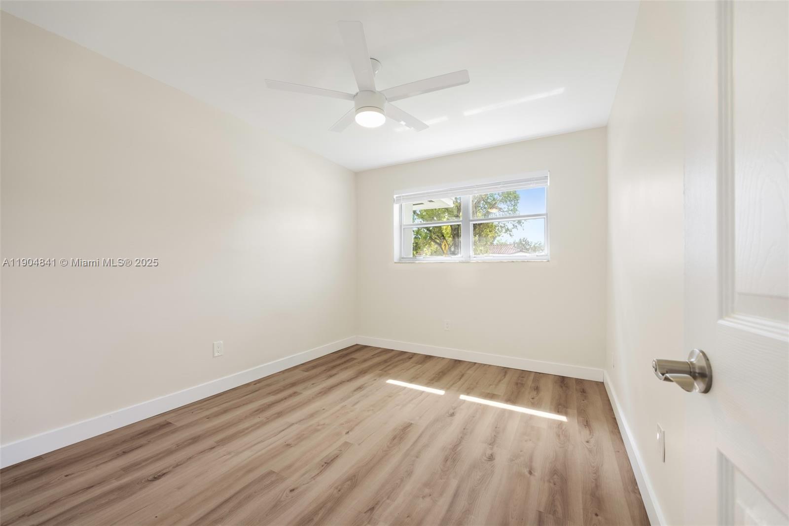 3101 Southwest 19th Street, Unit 3101 Miami, FL 33145 - Photo 12 of 15 an empty room with wooden floor and windows
