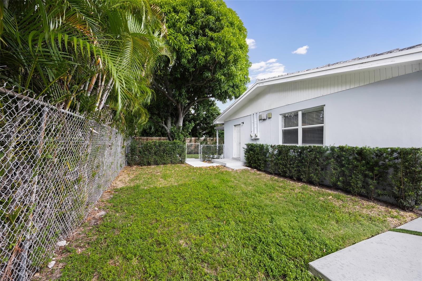 3101 Southwest 19th Street, Unit 3101 Miami, FL 33145 - Photo 14 of 15 a front view of a house with a yard