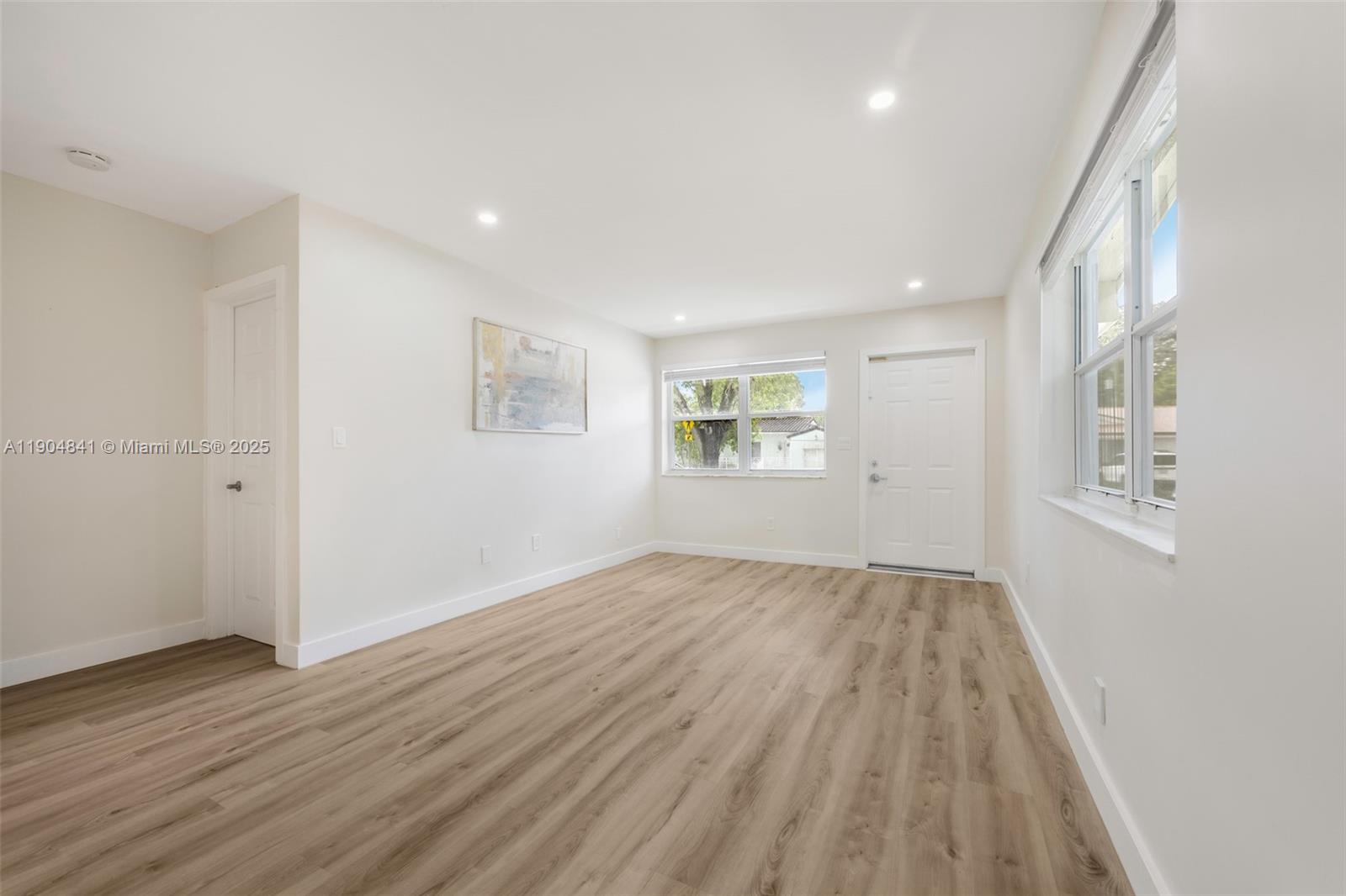 3101 Southwest 19th Street, Unit 3101 Miami, FL 33145 - Photo 4 of 15 an empty room with wooden floor and windows
