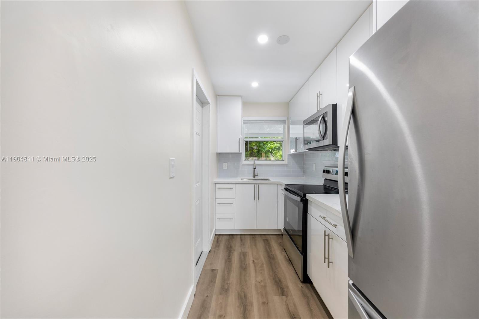 3101 Southwest 19th Street, Unit 3101 Miami, FL 33145 - Photo 5 of 15 a kitchen with cabinets and stainless steel appliances