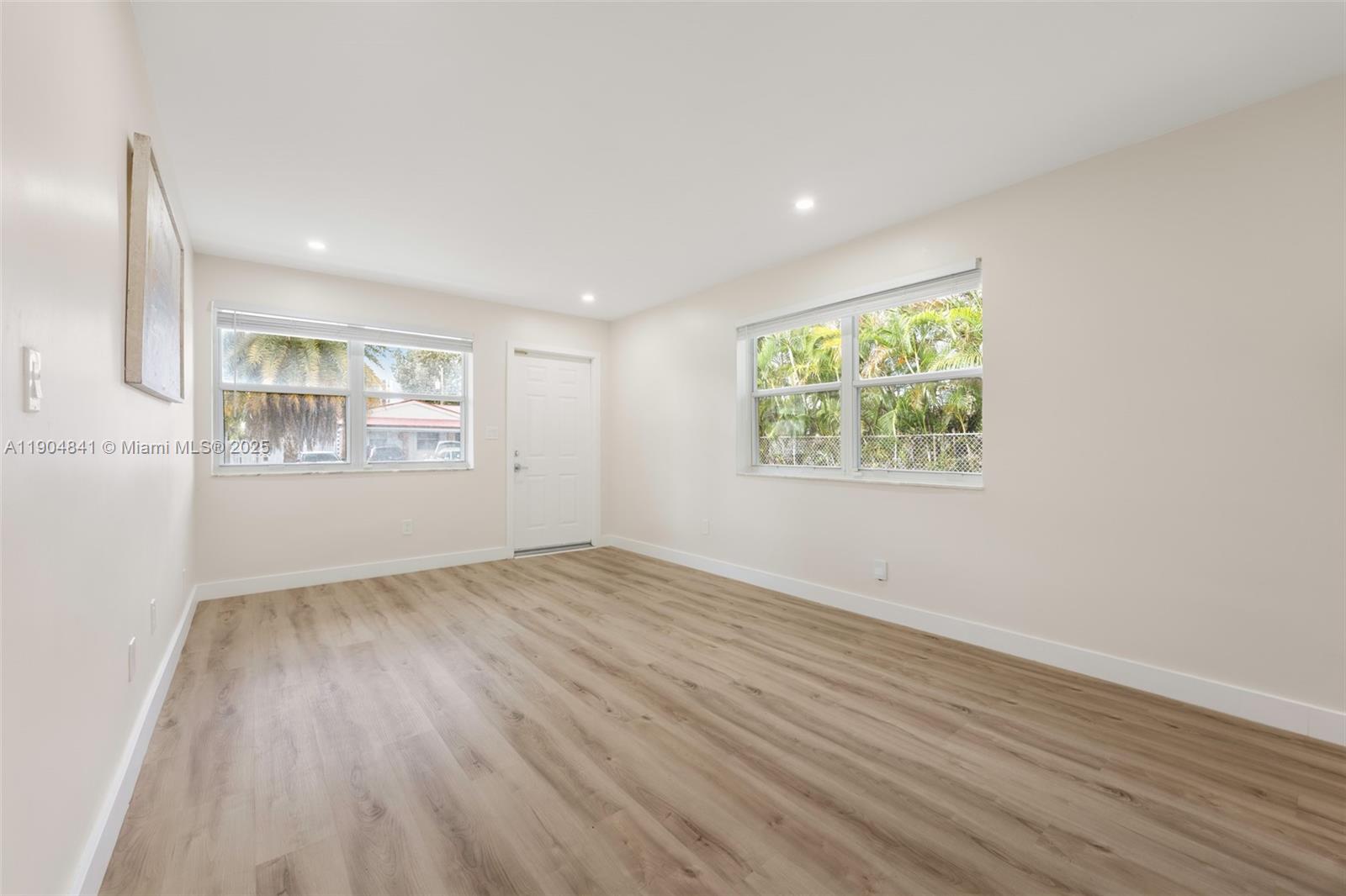 3101 Southwest 19th Street, Unit 3101 Miami, FL 33145 - Photo 6 of 15 an empty room with wooden floor and windows