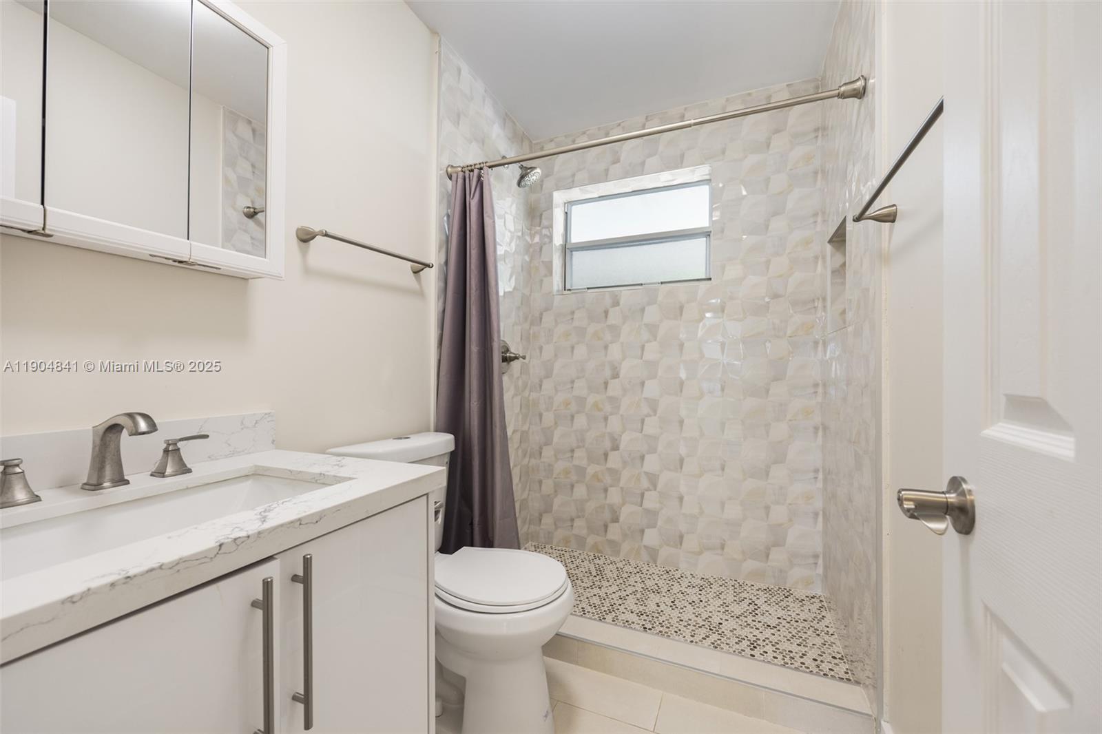 3101 Southwest 19th Street, Unit 3101 Miami, FL 33145 - Photo 7 of 15 a bathroom with a sink a toilet and shower