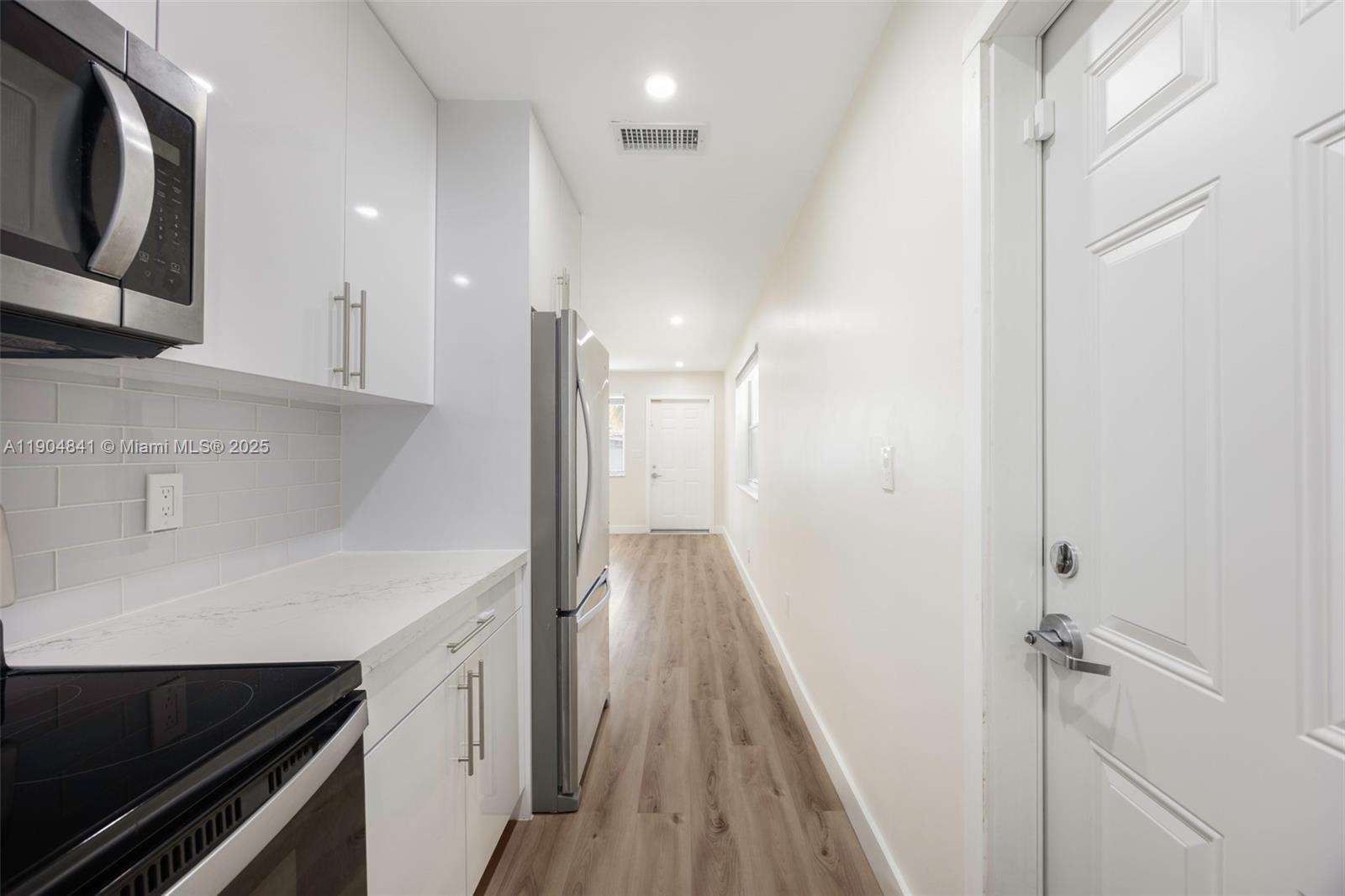 3101 Southwest 19th Street, Unit 3101 Miami, FL 33145 - Photo 10 of 15 a view of a hallway with wooden floor and staircase