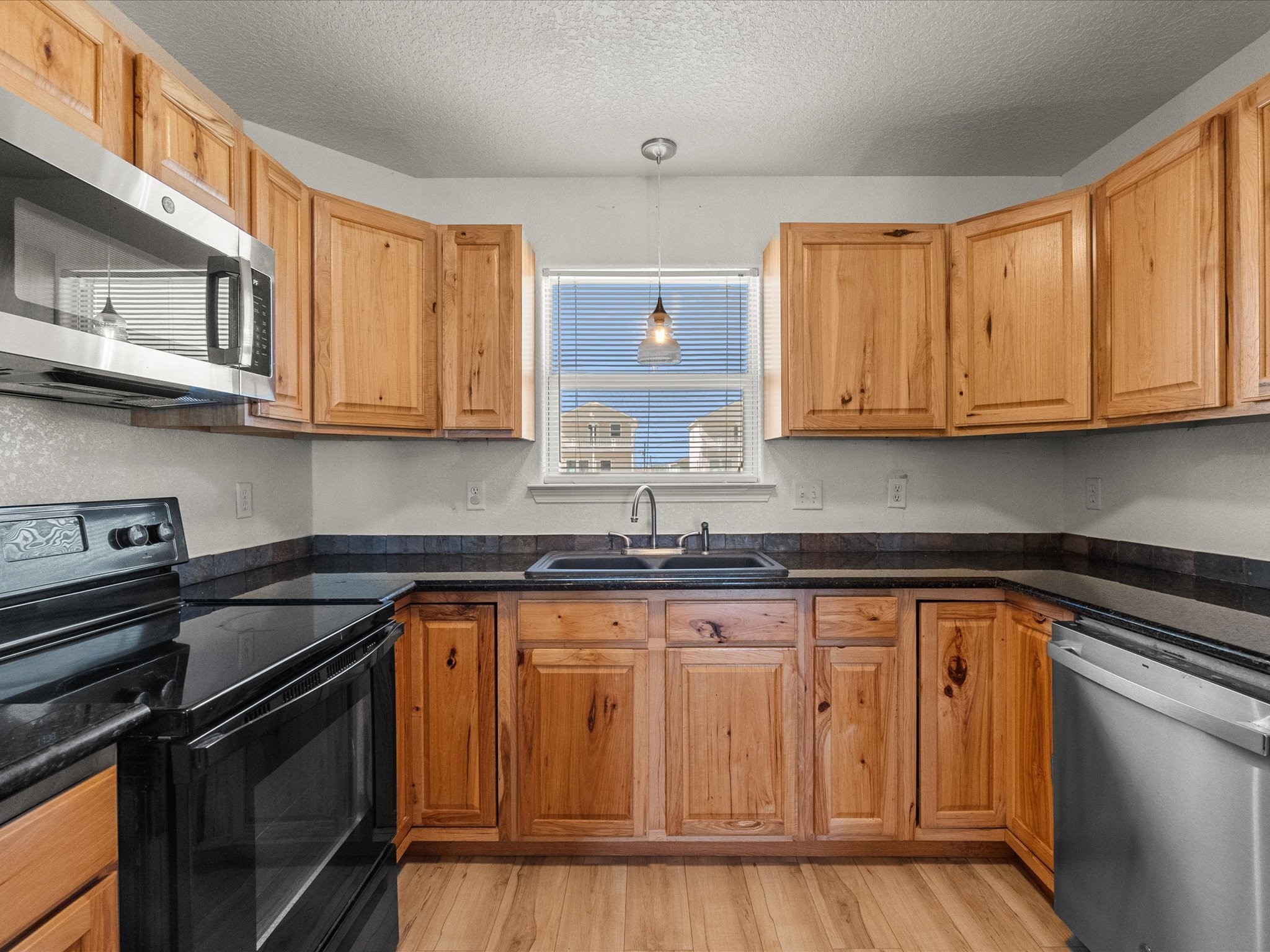 127 Howard Avenue Surfside Beach, TX 77541 - Photo 14 of 29 a kitchen with stainless steel appliances granite countertop a sink stove and cabinets