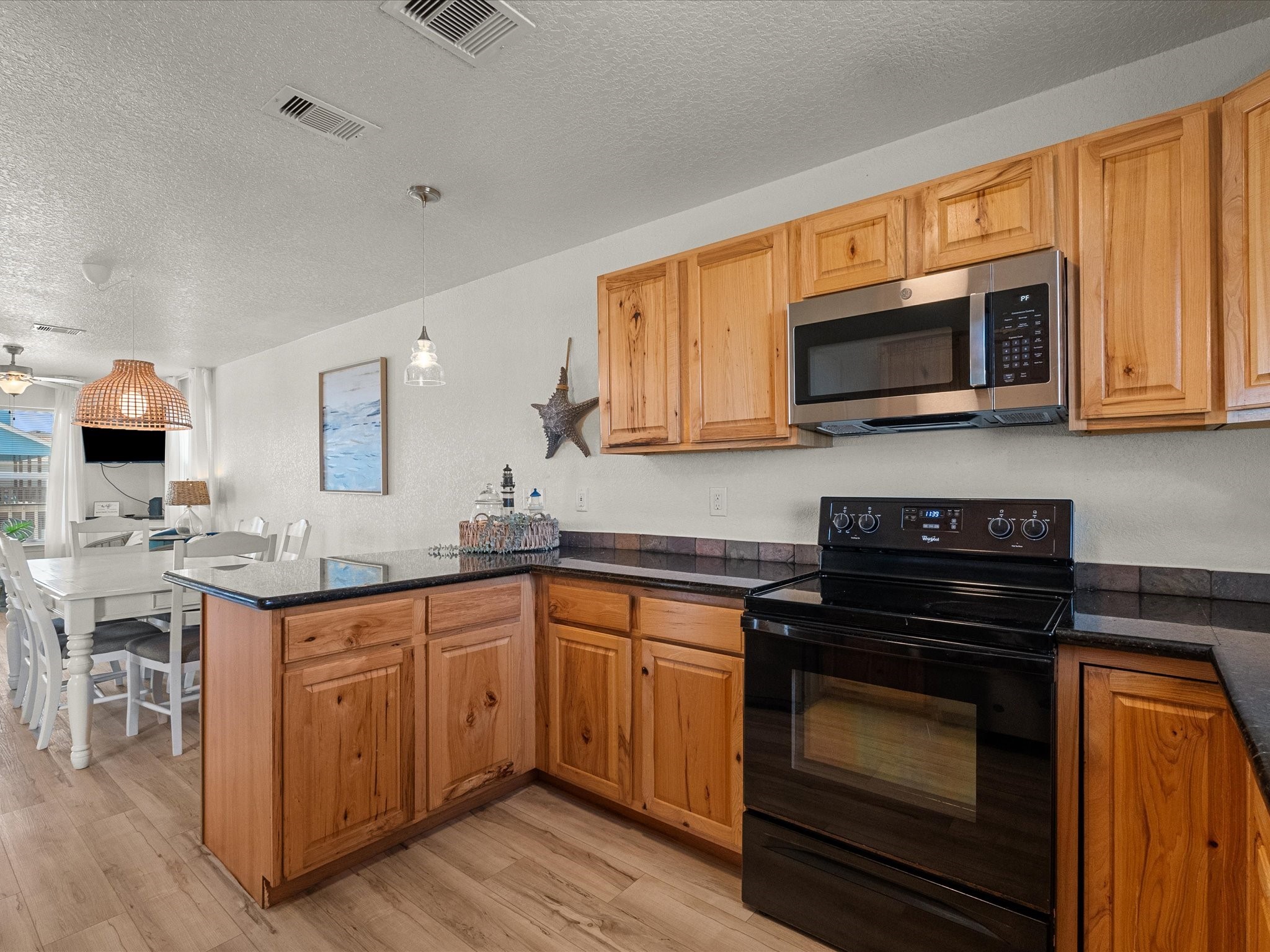 127 Howard Avenue Surfside Beach, TX 77541 - Photo 15 of 29 a kitchen with stainless steel appliances granite countertop a stove top oven a sink dishwasher and white cabinets