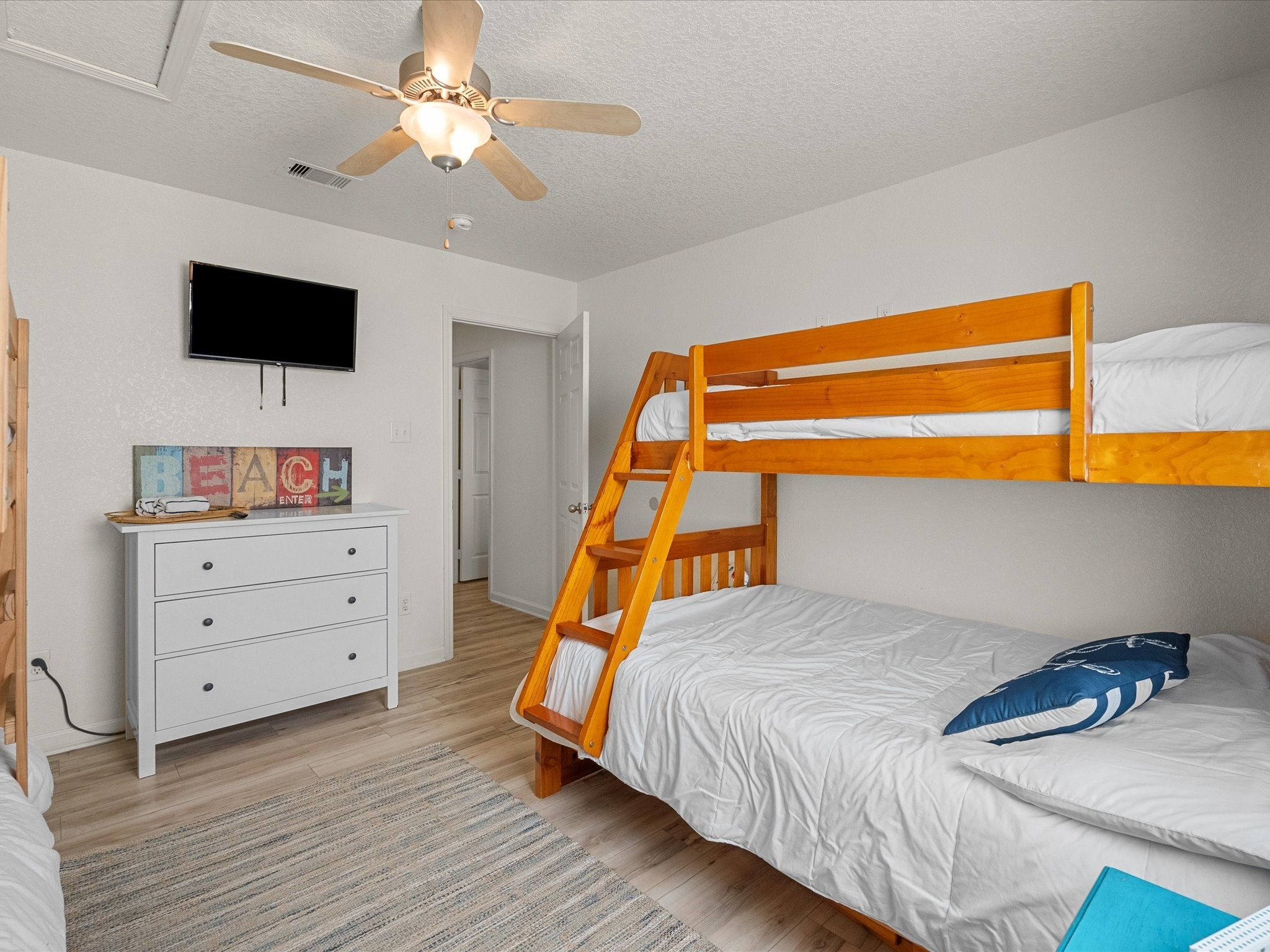127 Howard Avenue Surfside Beach, TX 77541 - Photo 20 of 29 a bedroom with a bed and a flat screen tv