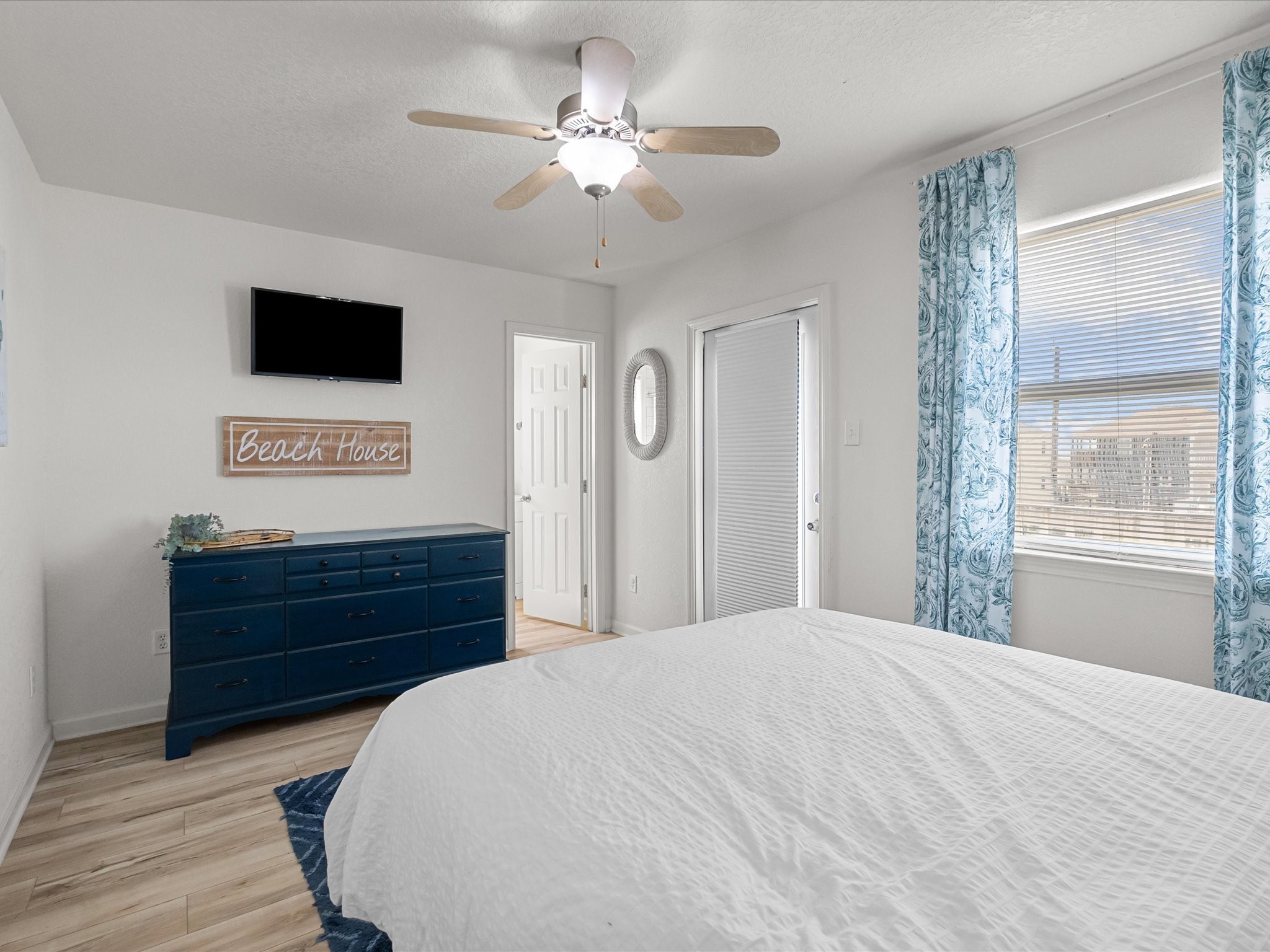 127 Howard Avenue Surfside Beach, TX 77541 - Photo 21 of 29 a bed room with a bed mirror and a window