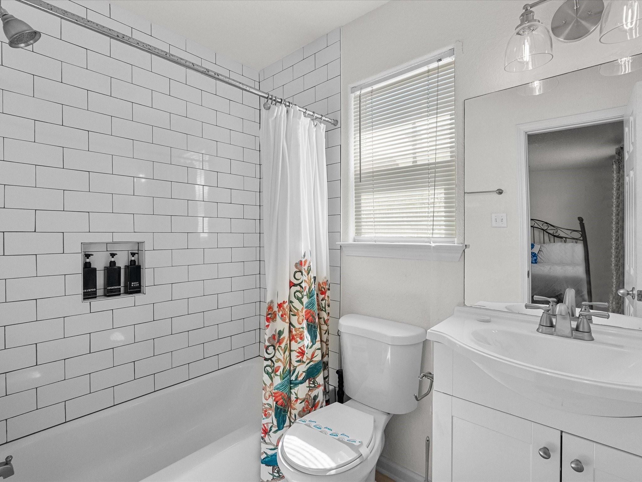 127 Howard Avenue Surfside Beach, TX 77541 - Photo 23 of 29 a bathroom with a sink a toilet a mirror and shower curtain