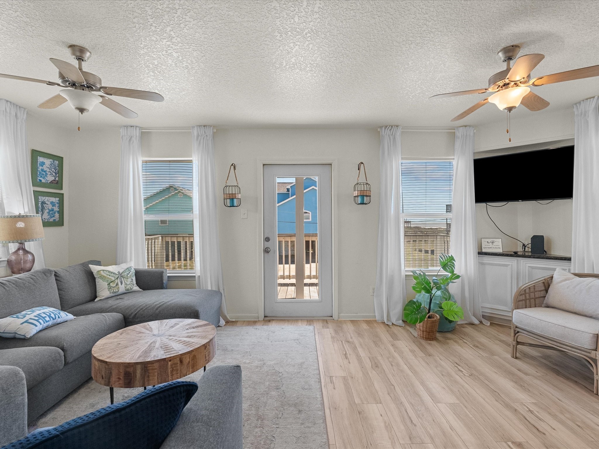 127 Howard Avenue Surfside Beach, TX 77541 - Photo 9 of 29 a living room with furniture a ceiling fan and a flat screen tv
