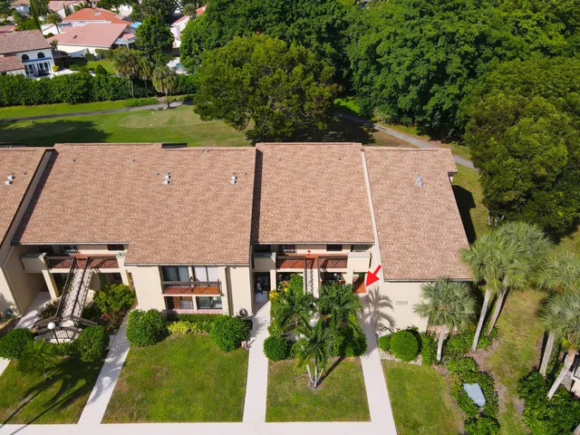 an aerial view of a swimming pool with outdoor seating