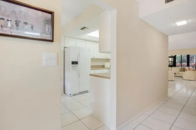 a kitchen with white cabinets appliances and a sink