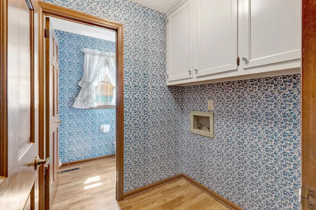 a view of a room with a table and chairs