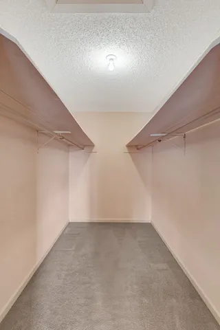 an aerial view of residential house with outdoor space and trees all around