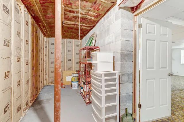 an aerial view of a residential houses with outdoor space and trees