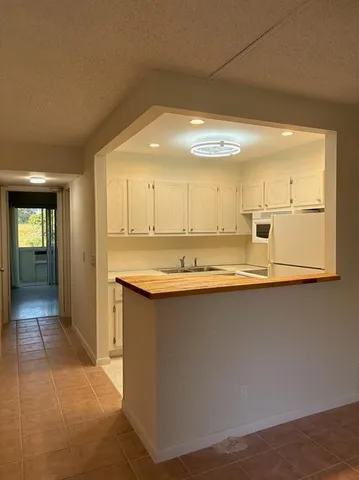 a view of kitchen with stainless steel appliances granite countertop sink and cabinets