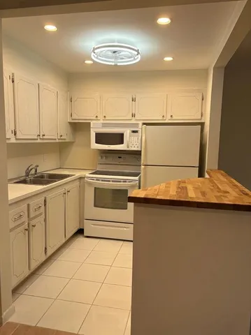 a kitchen with stainless steel appliances granite countertop a sink and cabinets
